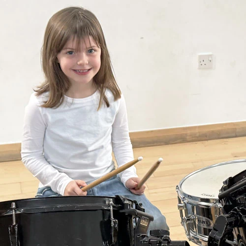 girl with drum sticks