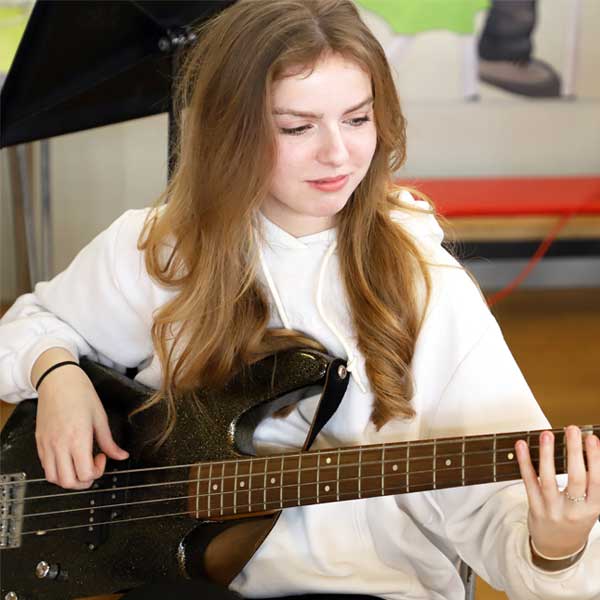 Image of girl playing bass guitar