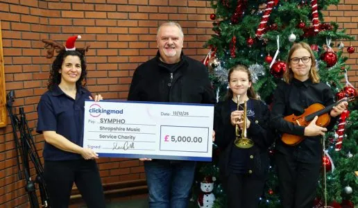 Shaun Carvill from Clickingmad donating a cheque to Sympho charity