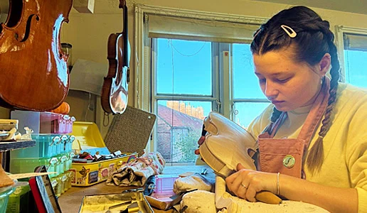 young lady making a violin