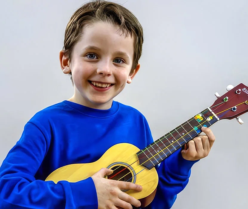 boy playing ukulele